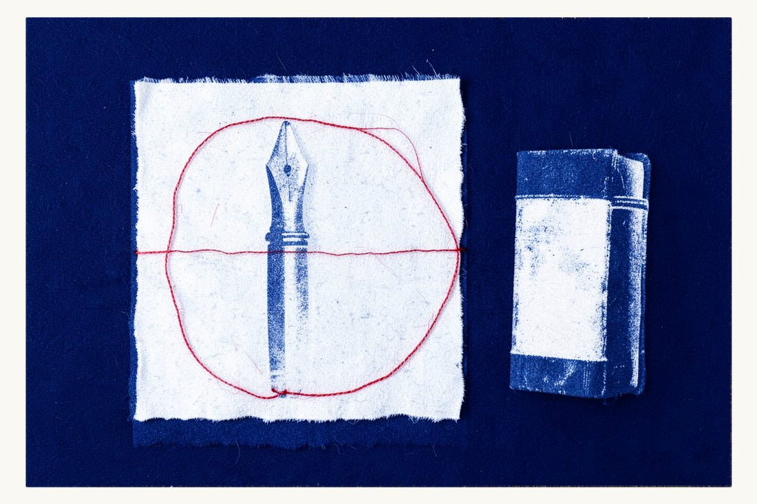 Drafting an arbitration clause for a contract: a fountain pen on a blank sheet inside a closed red thread circle, a thick antique book left outside, cyanotype print