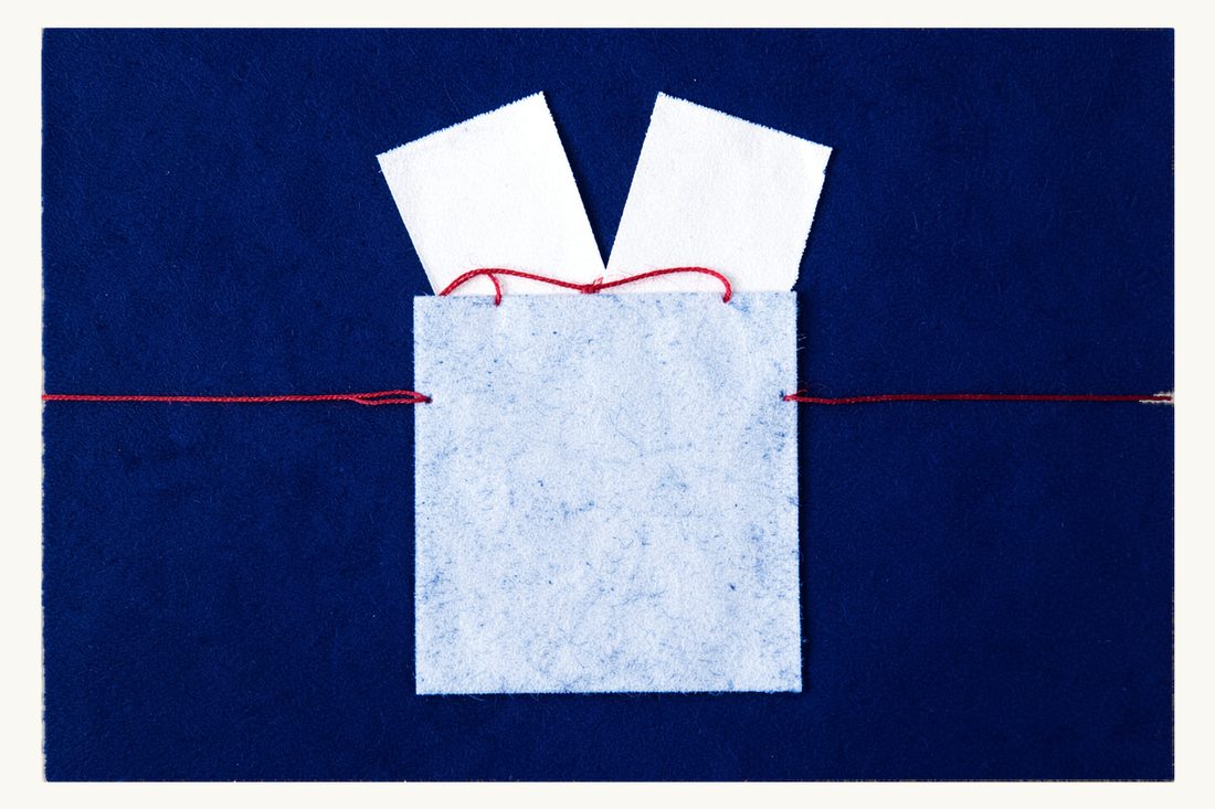 Documents needed to enforce a foreign award: a large blank document folder with exactly two blank sheets of paper sticking out of its top, bound together by one red thread loop, cyanotype print