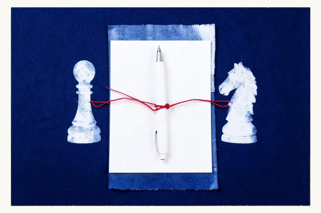 Power of attorney in Turkey for foreigners: a blank sheet with a fountain pen, a chess pawn on one side and a chess knight on the other, a red thread tied around the pen between them, cyanotype print