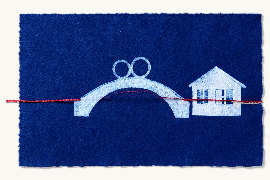 Governing law for prenuptial agreements of foreign couples: a simple arched bridge with two wedding rings at its crest and a house at its right end, a red thread running along the deck, cyanotype print