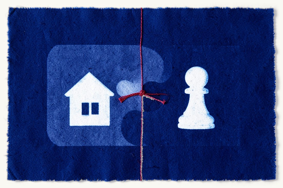 Resolving a rental dispute through mediation: two large interlocking puzzle pieces, a small house on one and a chess pawn on the other, joined by a knotted red thread, cyanotype print