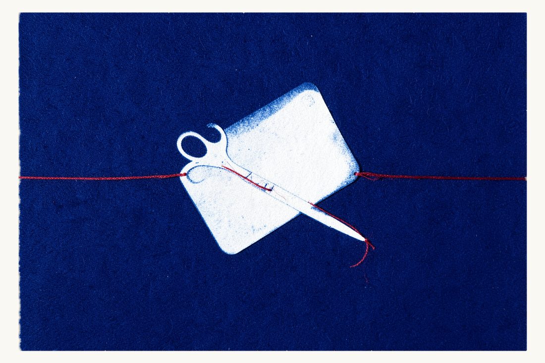 Fintech sanctions, fines and liability in Türkiye: a large blank payment card with a small chip, open scissors closing on its corner, a red thread cut in two, cyanotype print