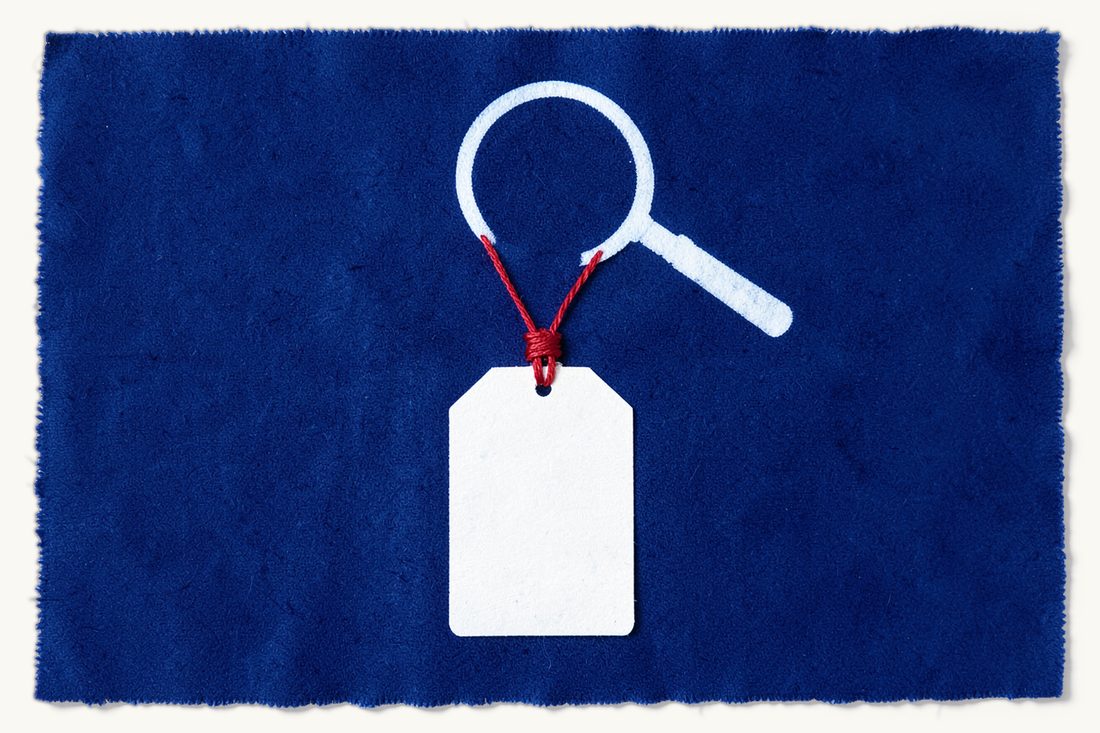Competition and antitrust law in Türkiye: three blank price tags knotted together by a red thread under a large magnifying glass, cyanotype print