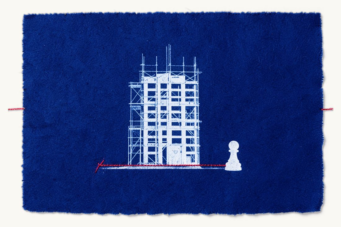 Construction and zoning law for foreign parties in Türkiye: a scaffolded building rising inside a red-thread plot boundary, a small chess pawn outside, cyanotype print