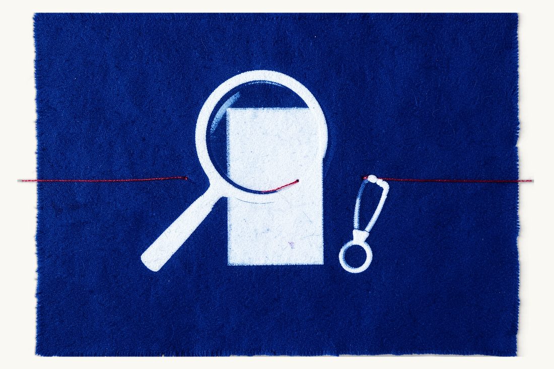 Informed consent and the consent form: a large magnifying glass enlarging a small blank sheet with a loop of red thread at its foot, a small stethoscope beside it, cyanotype print