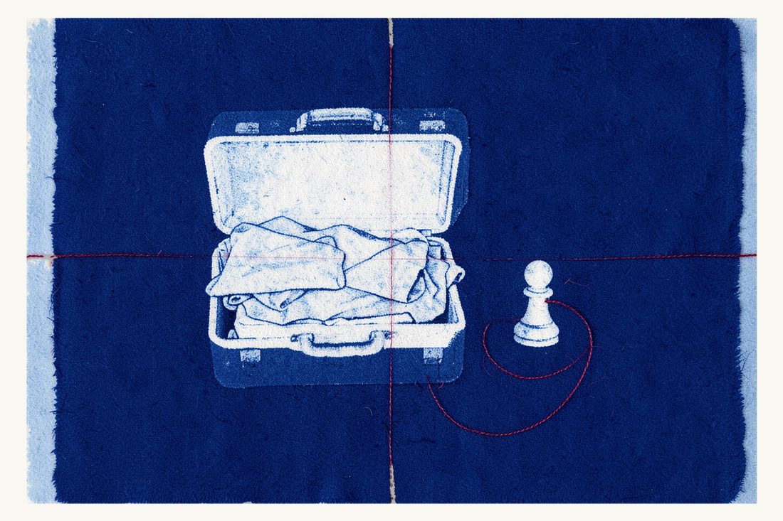 Living in Türkiye on a residence permit: a large open suitcase fully unpacked beside a neat pile of folded clothes, a white chess pawn, and a red thread circling them, cyanotype print